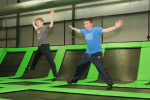 Two Boys on Trampolines Laughing and Jumping on Trampolines